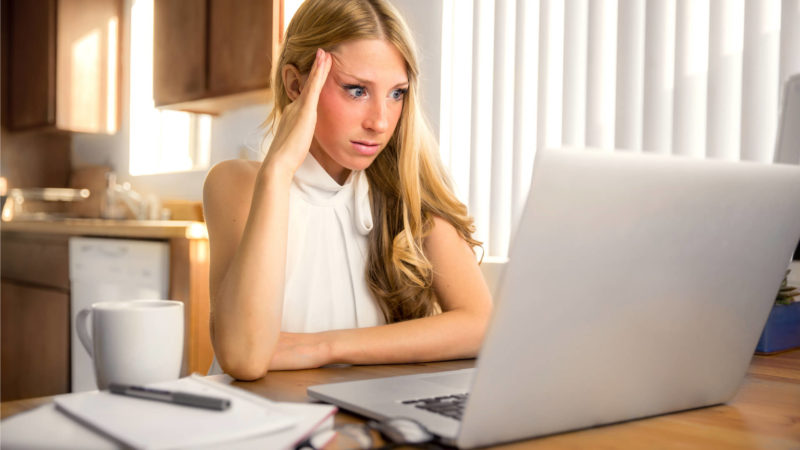 Frustrated woman at laptop