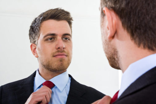 shutterstock_137338826-man-looking-in-mirror