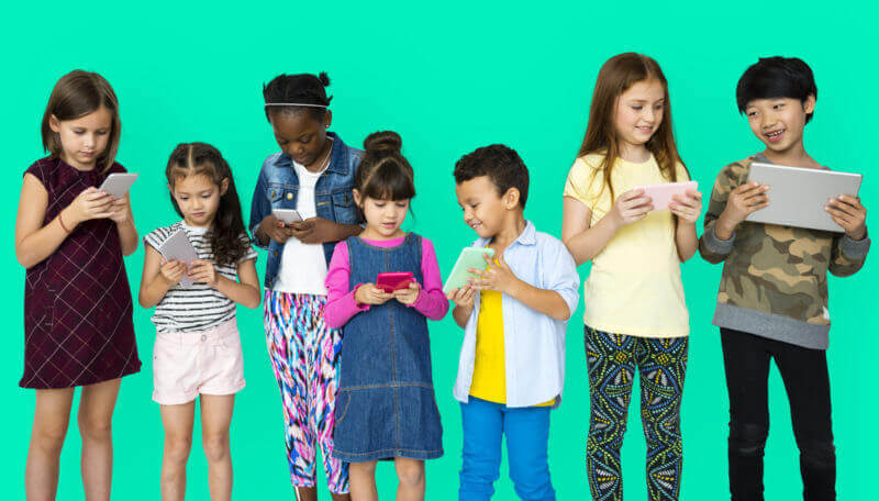 Group Of Kids On Devices