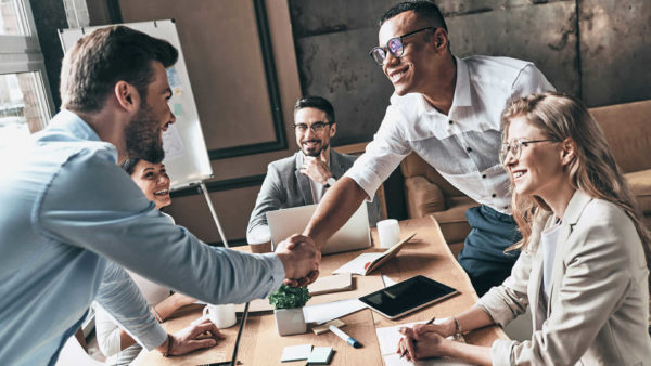 team-handshake-over-work-table-stock-1920