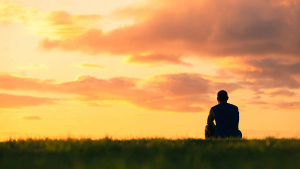 man-medidating-at-sunset-stock-1920