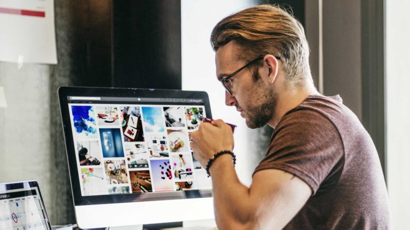 Man reviewing digital assets on screen