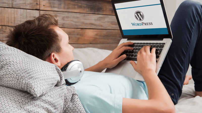 Man using WordPress on laptop