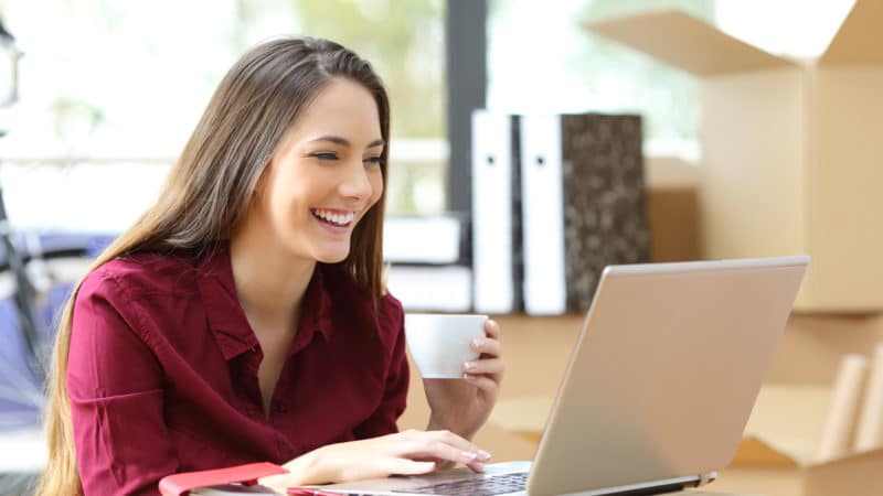 Woman smiling while reading emails in a digital-first experience