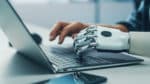 Human hand and AI robot hand gtyping on same keyboard