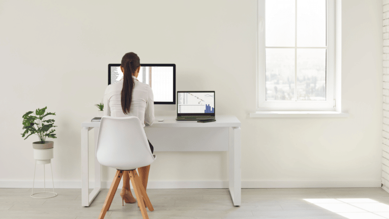 Woman working on computer in a spacious room