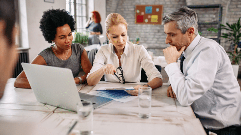 Group of business people going through business plans