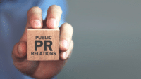 Man-holding-wooden-cube-with-the-word-public-relations