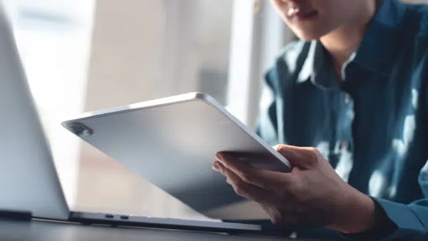 Woman-using-digital-tablet-and-laptop-computer