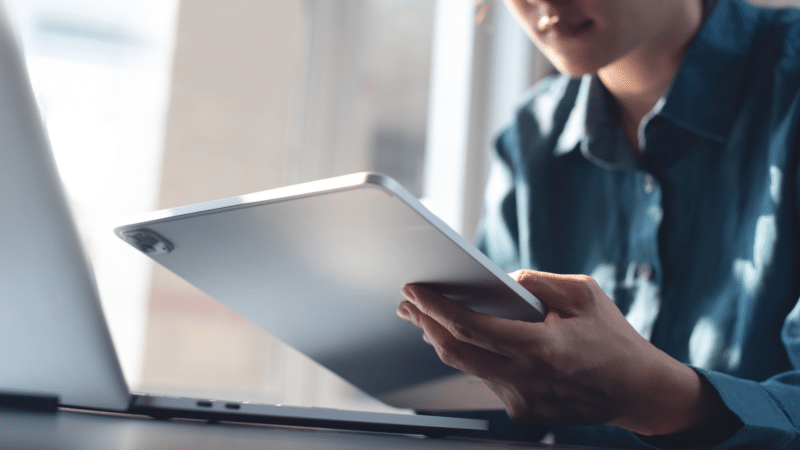 Woman using digital tablet and laptop computer