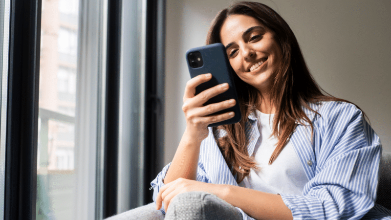 Woman using smartphone to read blog