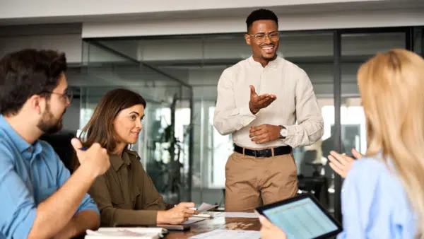 Young-happy-male-executive-discussing-marketing