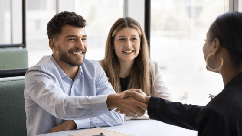 Business partners giving handshake at meeting