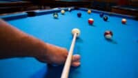 Man-playing-pool-taking-a-shot