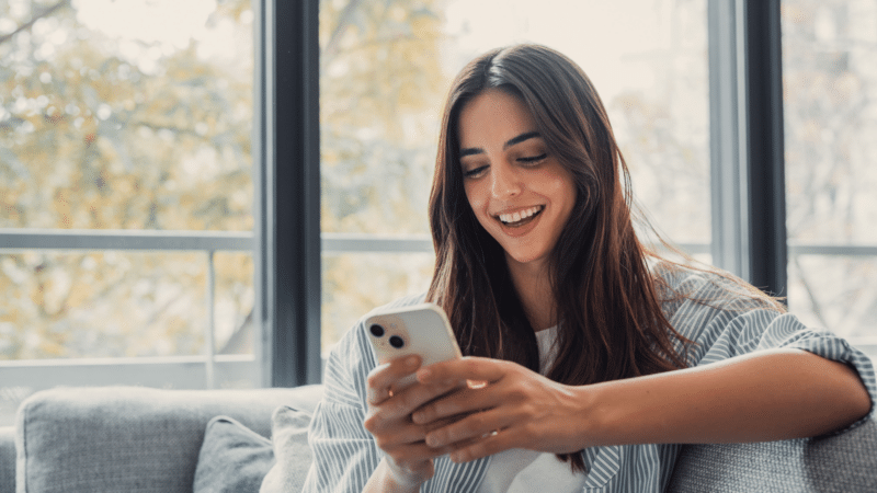 Woman holding smartphone, checking email or SMS