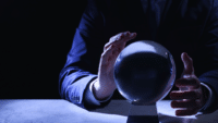 Businessman-using-crystal-ball-to-predict-future