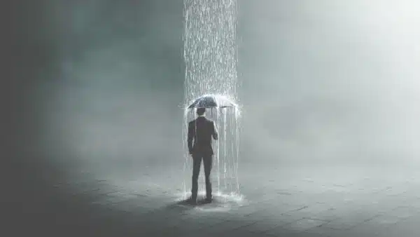 Businessman-using-an-umbrella-surreal-concept