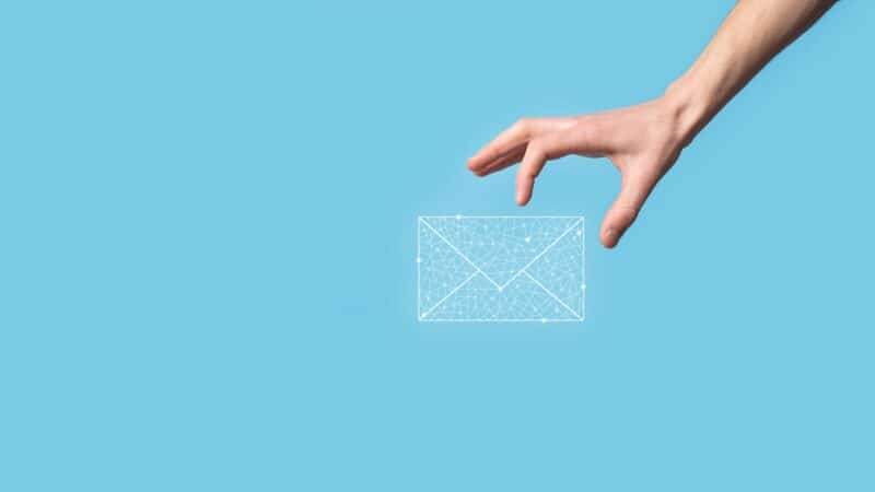 Hand holding envelope - Email marketing concept
