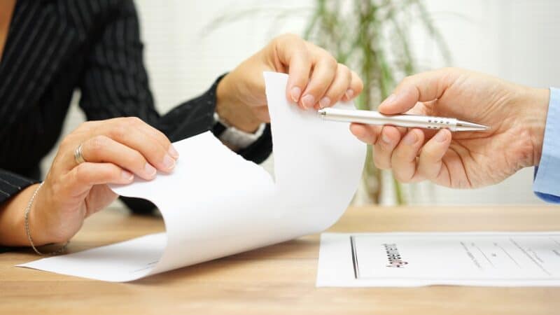 Woman tears agreement documents