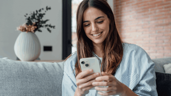 Smiling-woman-looking-at-smartphone-screen