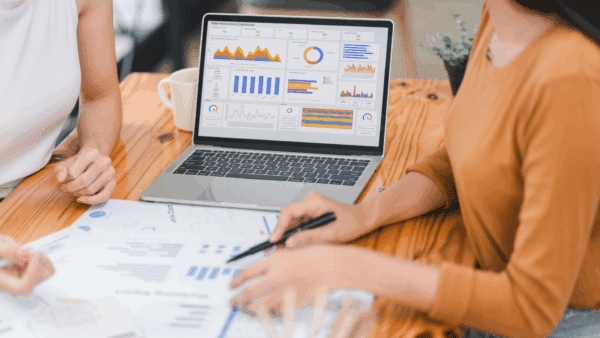 Two-professionals-analyzing-business-data-on-dashboard-screen