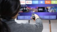 A-woman-experiences-OTT-service-using-a-smart-TV-at-home