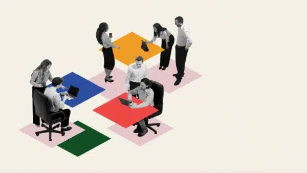 Employees-sitting-at-different-tables-cooperating-with-each-other